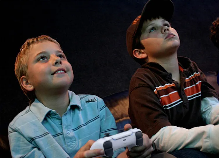 Kids playing video games with their friends at a GameTruck party
