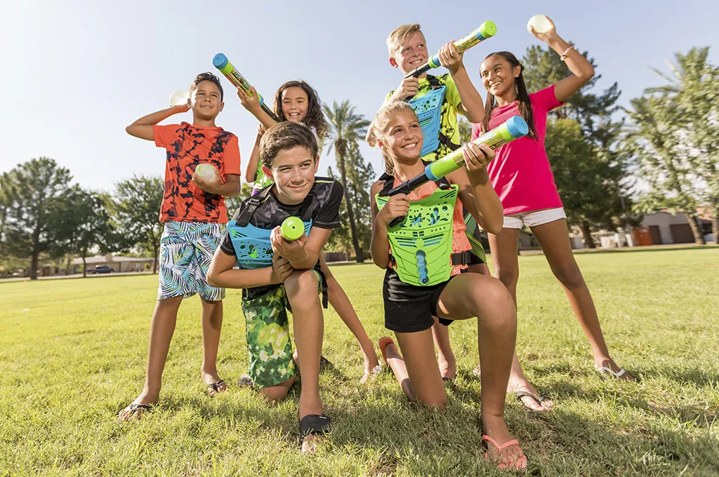 Kids wearing colored team vests during a GameTruck WaterTag water battle