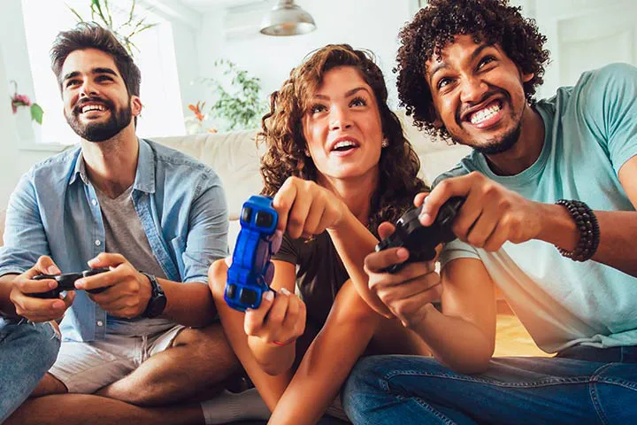 Diverse group of adults playing video games together with controllers at a Gameplex event